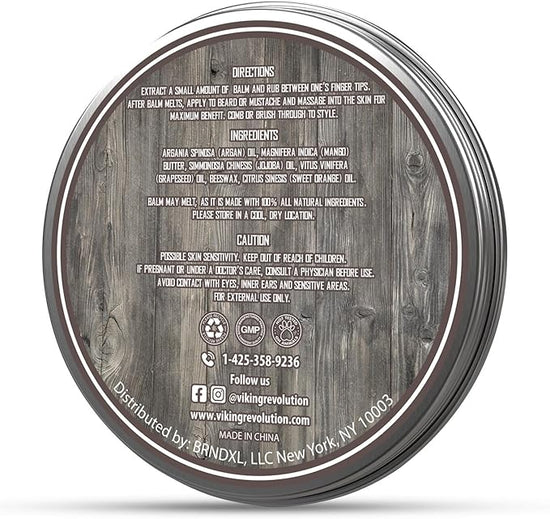 A jar of beard balm displayed on a wooden surface features instructions, ingredient list, and caution notes. Ideal for complementing your Beard Growth Kit to help you attain that desired appearance.