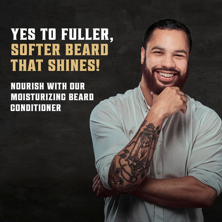 Man with tattoo smiles, arms crossed, promoting Palo Santo Beard Wash & Conditioner Set for fuller facial hair.