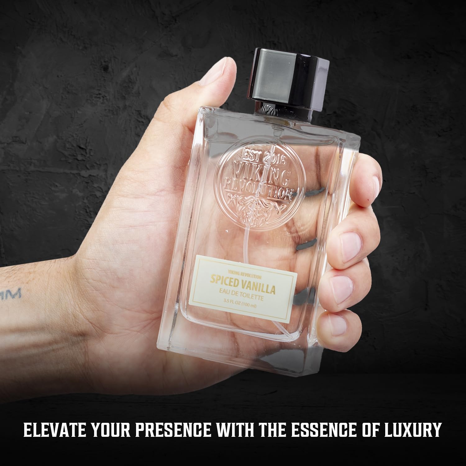 Hand holding Cologne for Men 3.5 fl oz bottle on dark background. Text: Elevate Your Presence with the Luxury of Spiced Vanilla Perfume.