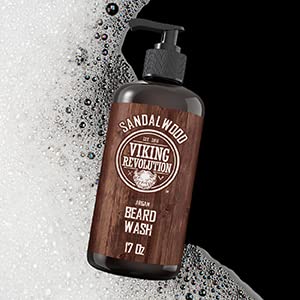Beard Wash 17oz with a pump and natural ingredients surrounded by white suds.