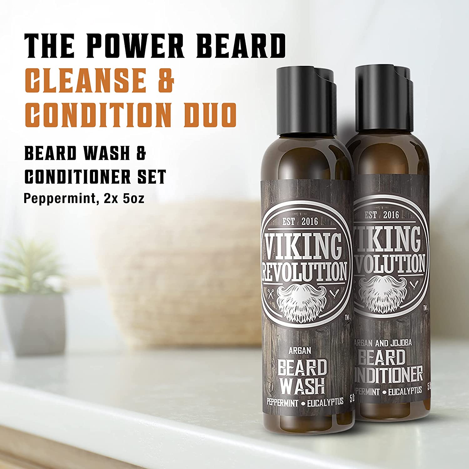 A pair of Peppermint & Eucalyptus Beard Wash & Conditioner Set bottles, each containing 5oz, rests on a bathroom counter alongside a small plant, delivering remarkable facial hair cleansing while addressing beard dandruff and ensuring vital skin protection.