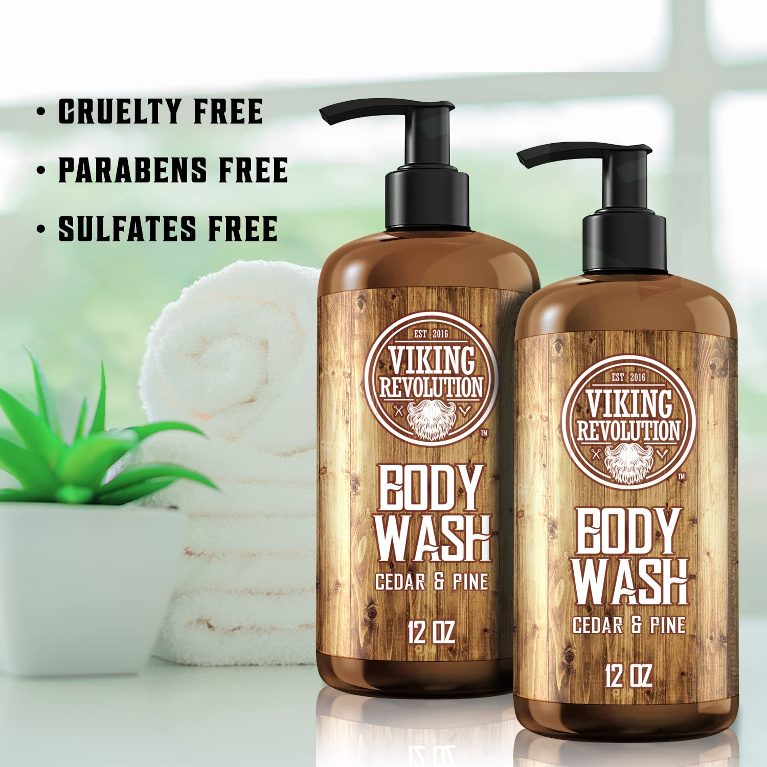 Two Cedar & Pine Body Wash bottles for active men are displayed with towels and a plant.