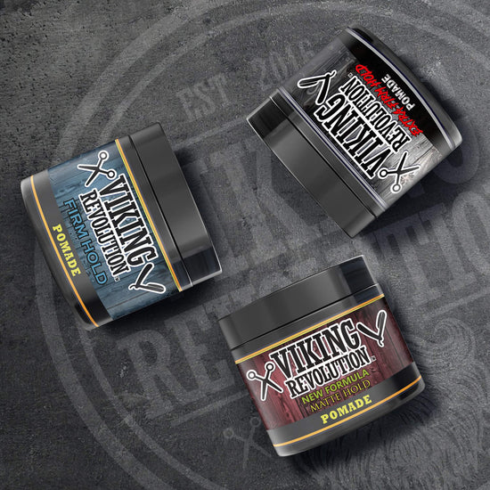 A set of Hair Pomade Mix - 3 Pack from Viking Revolution is arranged on a textured gray surface, ideal for creating any bold hairstyle.