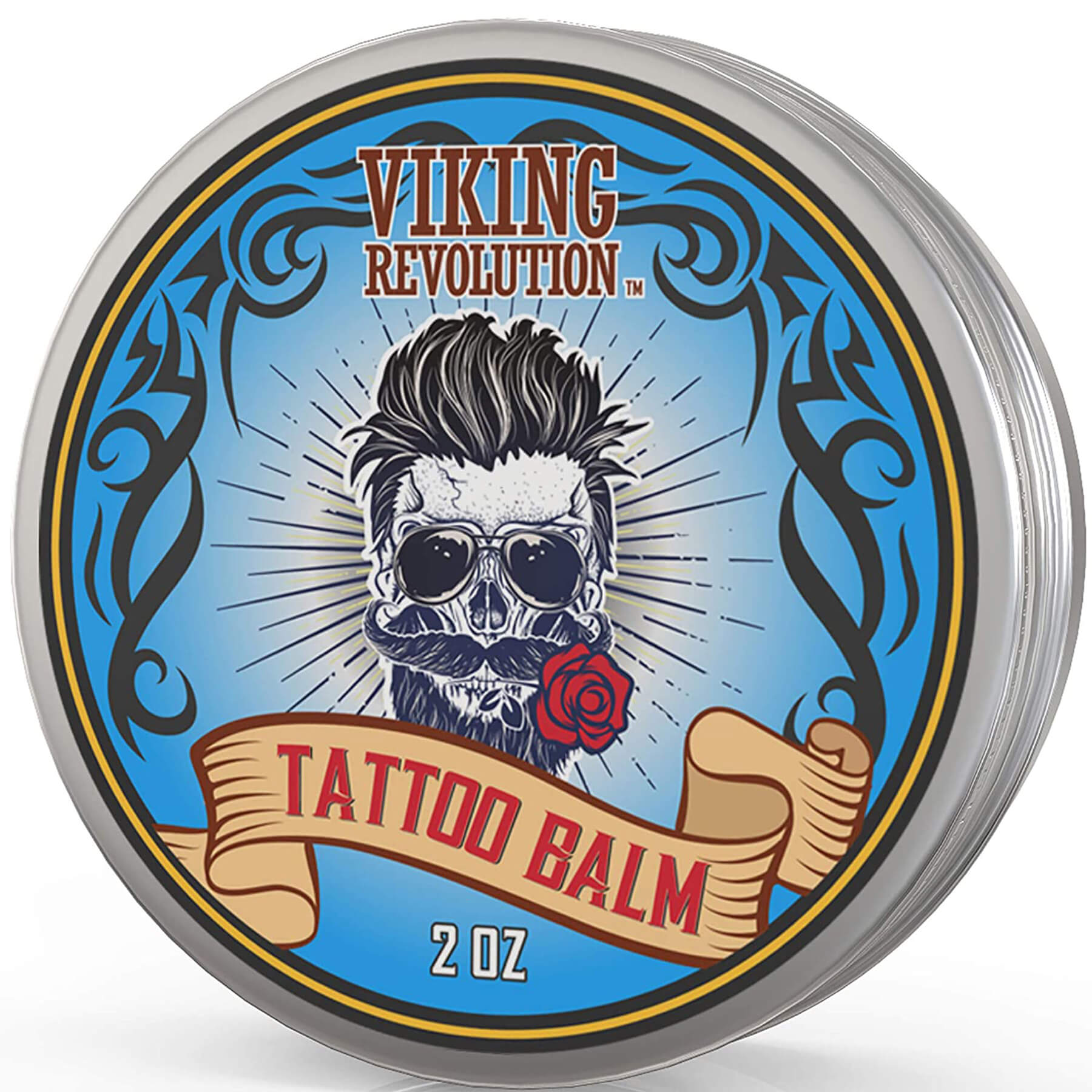 The Tattoo Care Balm tin showcases a skull design with sunglasses and a rose in its mouth. Made with vegan ingredients, it aids in tattoo recovery and enhances your tattoo skin care routine with a stylish touch.
